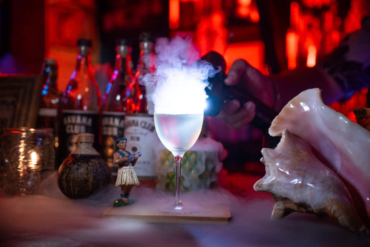 Smoking cocktail with hula girl figurine and conch shell