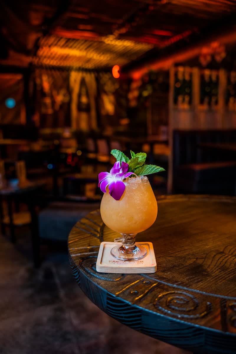 Tropical tiki cocktail with orchid garnish at Kaona Room speakeasy
