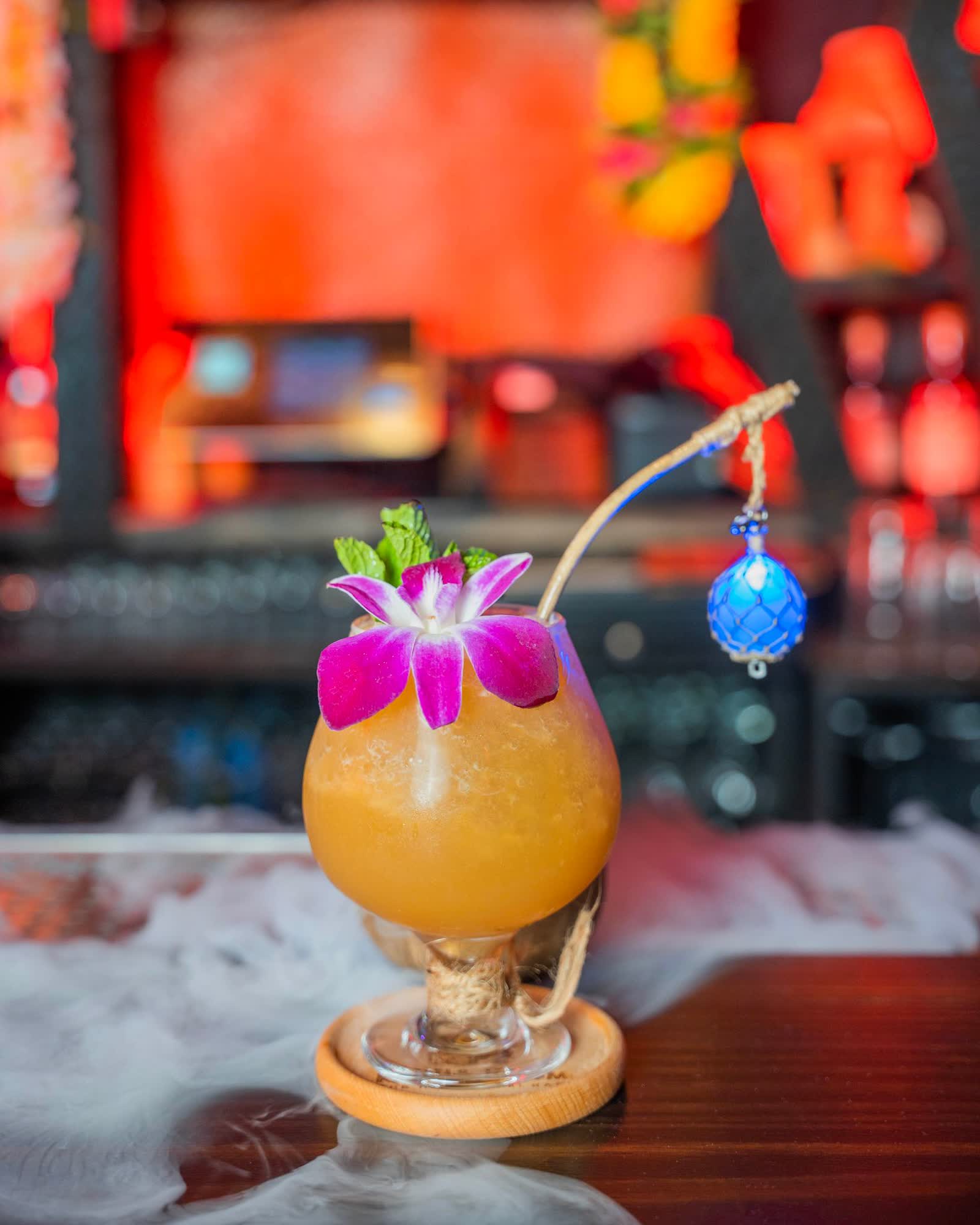 Tropical rum cocktail with orchid flower and dry ice smoke at Kaona Room tiki bar